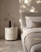 Table de chevet beige mat à bords arrondis avec tiroirs incurvés