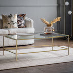 Table basse Champagne en métal avec plateau en verre biseauté