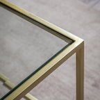Table basse Champagne en métal avec plateau en verre biseauté