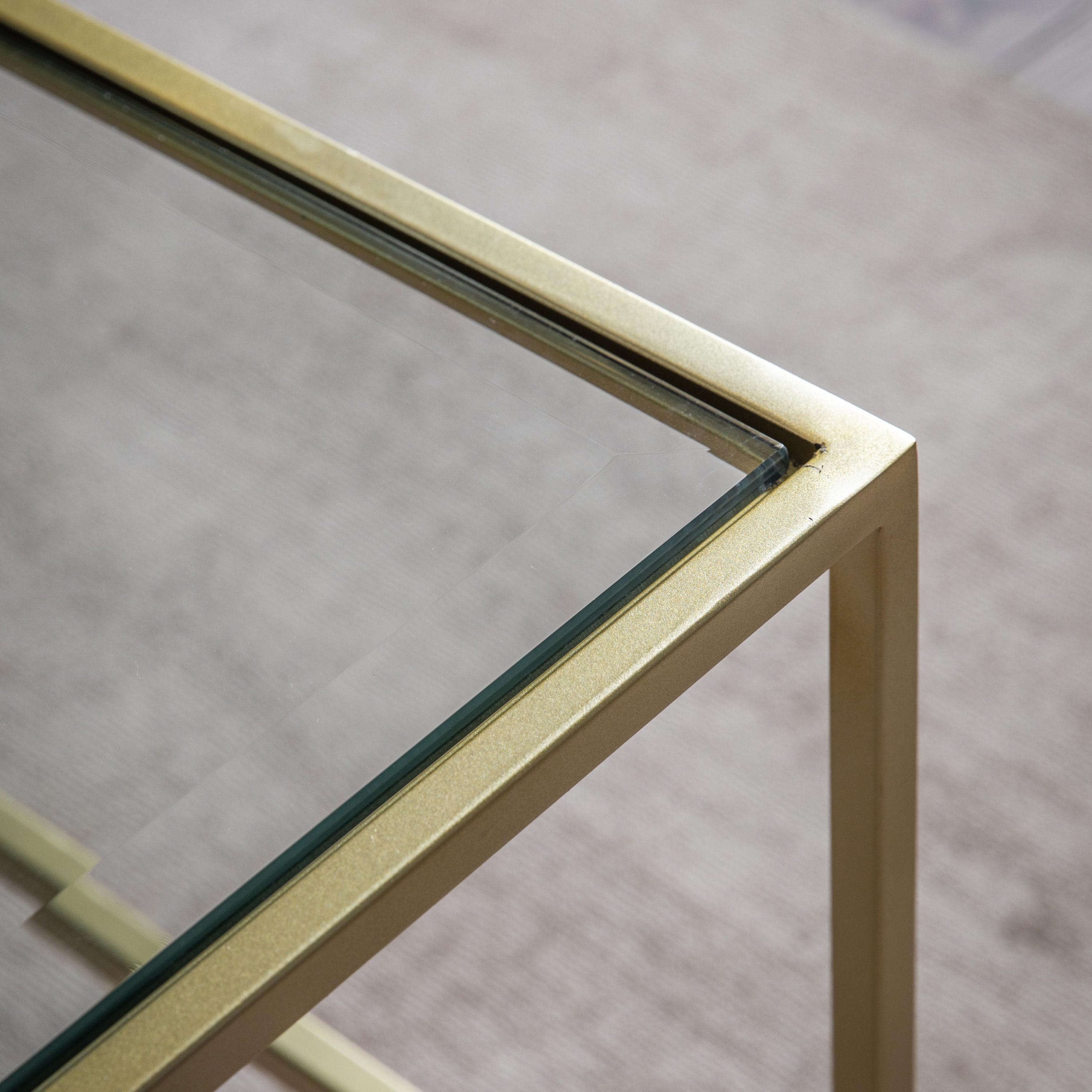 Table basse Champagne en métal avec plateau en verre biseauté